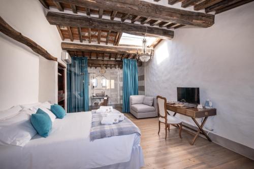 a bedroom with a bed and a desk with a computer at Podere Fontanino in Arezzo