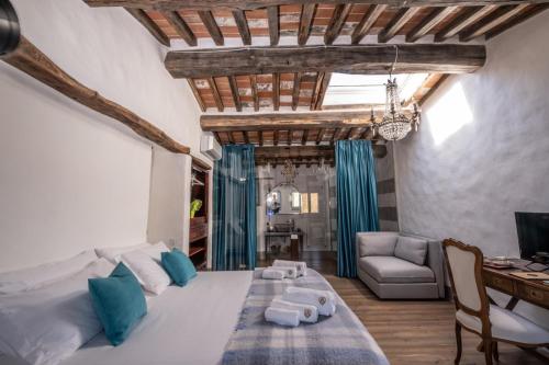 a bedroom with a large bed and a living room at Podere Fontanino in Arezzo