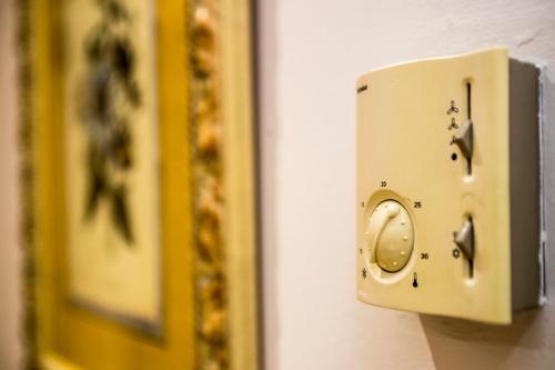 a lightswitch on a wall next to a mirror at Boutique Hotel Castilla in Soria