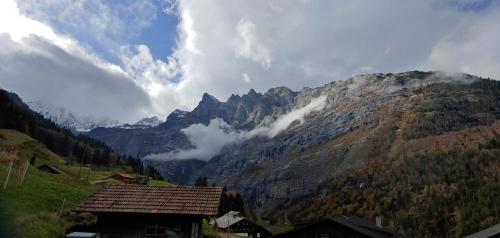 a view of a mountain with a house in the foreground at Ufem Egg Ferienwohnungen in Innertkirchen