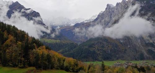 a valley with a town in the middle of a mountain at Ufem Egg Ferienwohnungen in Innertkirchen