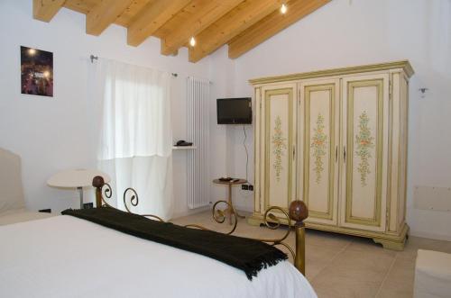 a bedroom with a bed and a wooden cabinet at B&B Marostica in Marostica