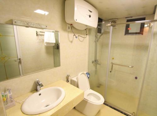 a bathroom with a toilet and a sink and a shower at Himalaya Sapa Hotel in Sa Pa