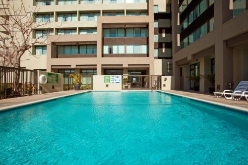 a large swimming pool in front of a building at Holiday Inn Palmdale-Lancaster by IHG in Palmdale