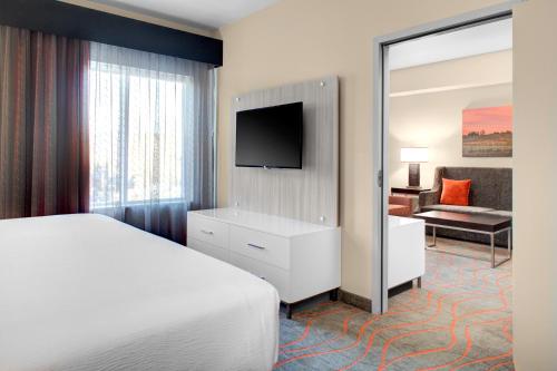 a hotel room with a bed and a television at Holiday Inn Windsor - Wine Country by IHG in Windsor