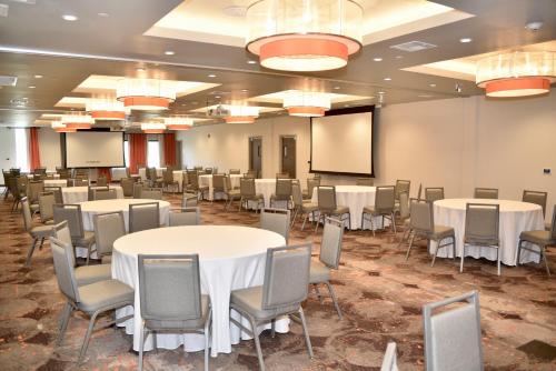 a conference room with tables and chairs and a podium at Holiday Inn Windsor - Wine Country by IHG in Windsor