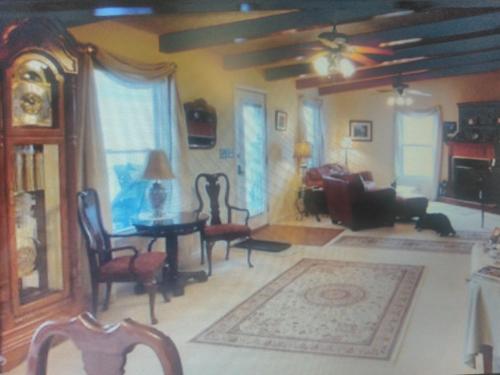 a living room with a couch and a table and chairs at Serenity Hill b&b in Sloans Crossing