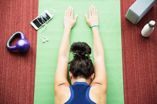 a woman is laying on a floor with her hands in the air at Hyatt Place New York City - Times Square in New York