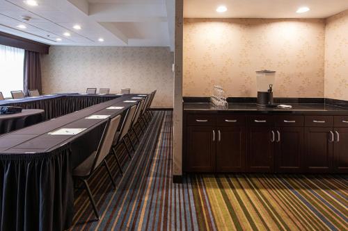a conference room with rows of tables and chairs at Holiday Inn St. Louis Airport West Earth City by IHG in Earth City