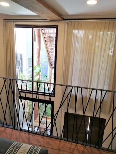 a balcony with a view of a window at Hotel Boutique TerraNova in Tulum