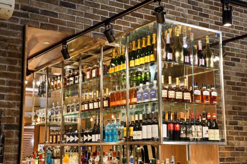 a large display case of bottles of alcohol at Holiday Inn Brentwood by IHG in Brentwood