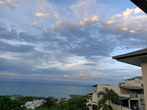 a cloudy sky over a city with houses at Whitsunday Reflections in Airlie Beach