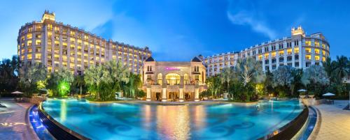 un hôtel avec une grande piscine en face de deux bâtiments dans l'établissement Crowne Plaza Resort Sanya Bay, an IHG Hotel, à Sanya