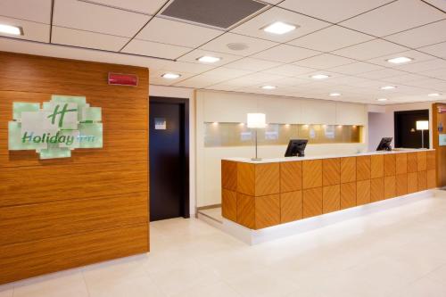 a lobby of a hospital with a reception desk at Holiday Inn Salerno-Cava De' Tirreni by IHG in Cava deʼ Tirreni