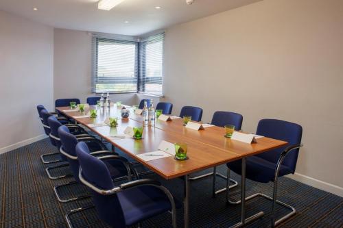 a conference room with a long table and chairs at Holiday Inn Taunton M5, Jct25 by IHG in Taunton