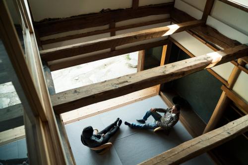 two people laying on the floor of a building at ume, in Yamazoe
