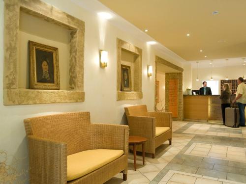 a waiting room with chairs and a counter at IDINGSHOF Hotel & Restaurant in Bramsche