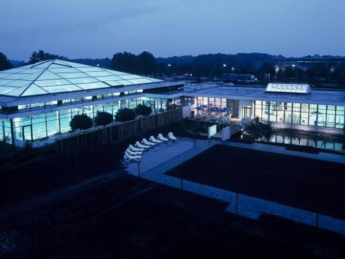 a large building with a lot of windows at night at IDINGSHOF Hotel & Restaurant in Bramsche