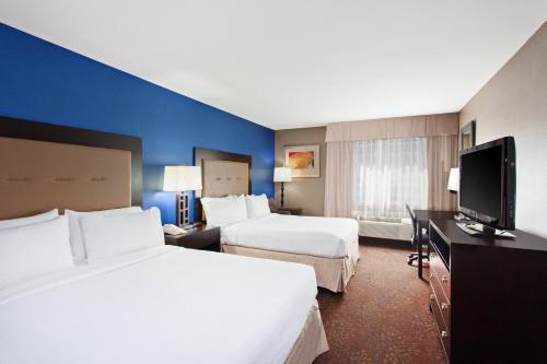a hotel room with two beds and a flat screen tv at Holiday Inn Seattle DWTN Lake Union by IHG in Seattle