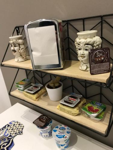 a shelf with a mirror and other items on it at centruMassimo b&b in Palermo