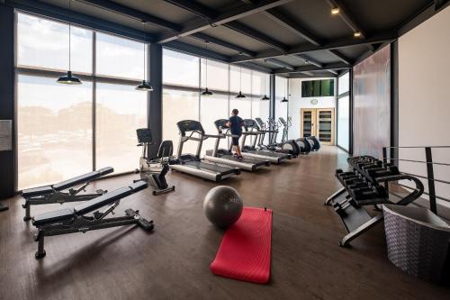 a person in a gym with treadmills and machines at Crowne Plaza Villahermosa by IHG in Villahermosa
