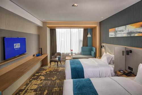 Cette chambre comprend 2 lits et une télévision à écran plat. dans l'établissement Holiday Inn Express Liaocheng Chiping, an IHG Hotel, à Liaocheng