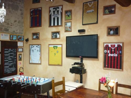 a room with a table and a tv and a chessboard at San Gennaro Castello in San Gennaro