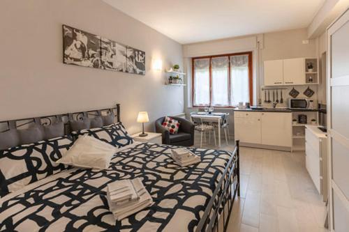 a bedroom with a large bed and a kitchen at La Casina di Mira in Montepulciano