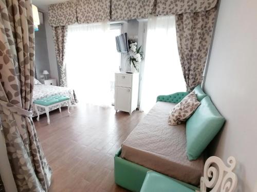 a room with a bed and a tv and a window at Hotel Nordic in Bellaria-Igea Marina