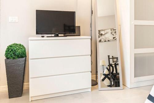 a white dresser with a television on top of it at La Casina di Mira in Montepulciano