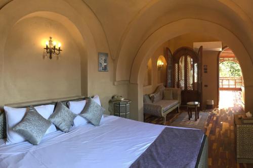 a bedroom with a white bed in a room at Djorff Palace in Luxor