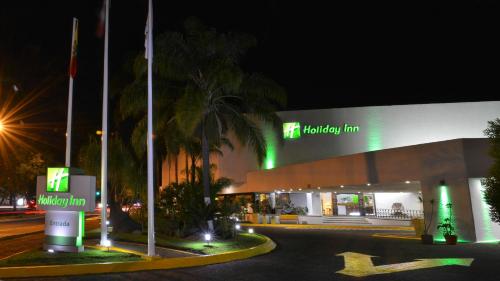 a shopping center at night with a building at Holiday Inn Morelia by IHG in Morelia