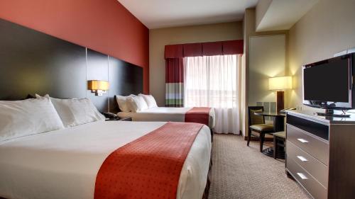 um quarto de hotel com duas camas e uma televisão de ecrã plano em Holiday Inn Meridian East I 59 / I 20 em Meridian