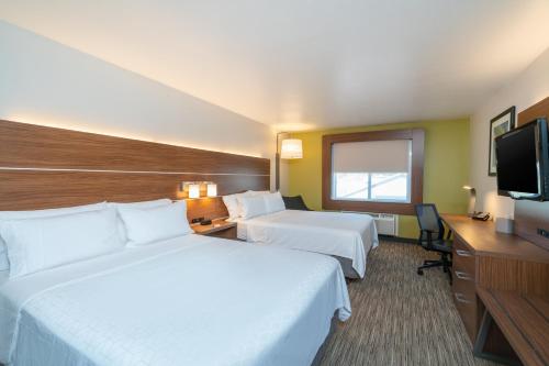 a hotel room with two beds and a flat screen tv at Holiday Inn Express Hotel & Suites Elkins by IHG in Elkins