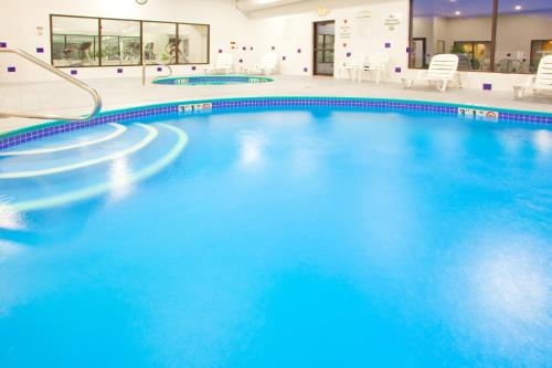a pool with blue water in a building at Holiday Inn Express Hotel & Suites Elkins by IHG in Elkins