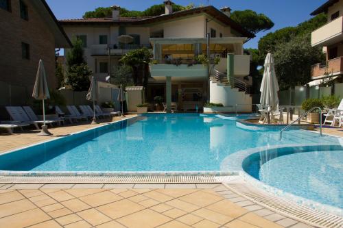 a large swimming pool in front of a building at Residence La Rotonda in Cervia