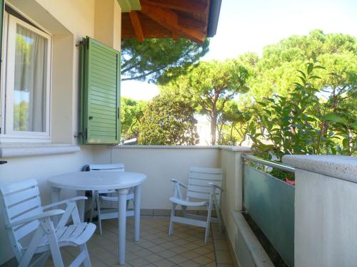 a patio with a table and chairs on a balcony at Residence La Rotonda in Cervia
