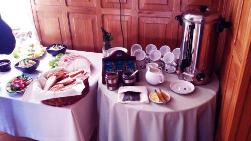 a table with a table cloth with food on it at Dworek Pokoje Gościnne in Olsztyn