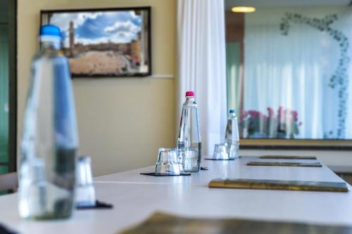 a counter top with bottles and glasses on it at Hotel Castello in Sovicille