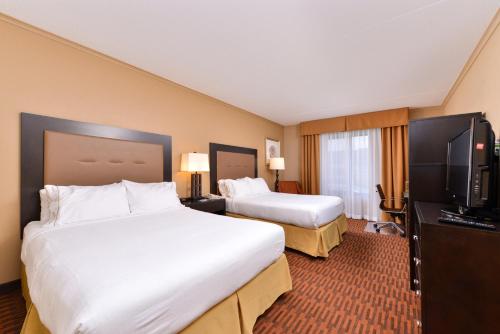 a hotel room with two beds and a flat screen tv at Holiday Inn Express Breezewood by IHG in Breezewood