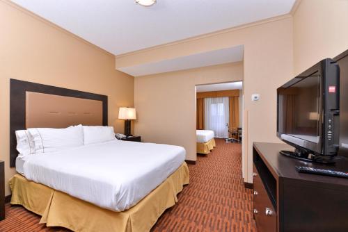 a hotel room with a bed and a flat screen tv at Holiday Inn Express Breezewood by IHG in Breezewood