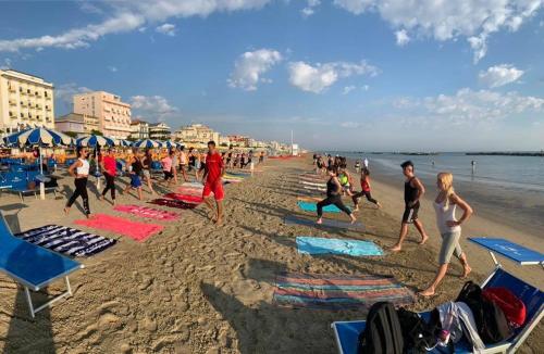 a group of people playing on the beach at Hotel Nordic in Bellaria-Igea Marina
