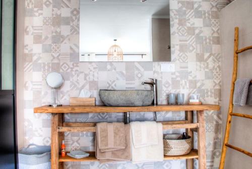 a bathroom with a sink and a counter with towels at Finca Pura, Clothing Optional Guestrooms in Elche
