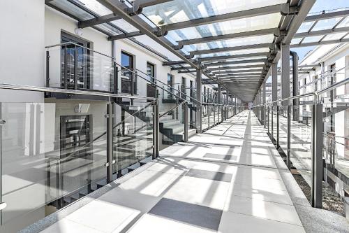 an empty hallway in a building with glass ceilings at TriApart Amber Jantar III in Jantar