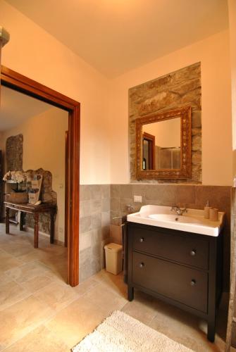 a bathroom with a sink and a mirror at B&B Casale delle farfalle in Tornolo