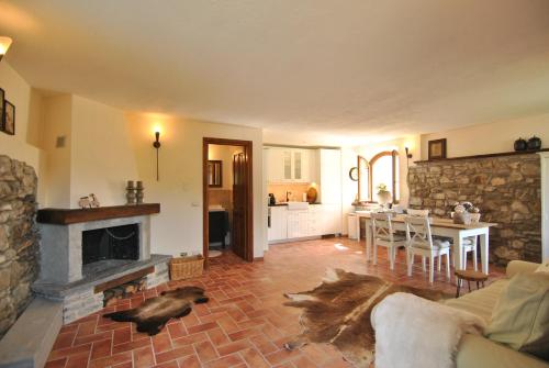a living room with a couch and a fireplace at B&B Casale delle farfalle in Tornolo