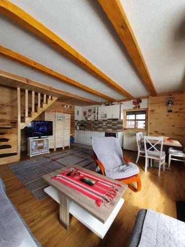 a large living room with a table and a kitchen at Holiday Home Vile Calimero in Žabljak