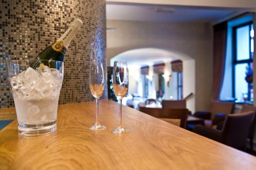 a bottle of champagne and two glasses on a table at Tyn Rhos Country House in Caernarfon