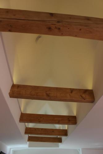 a ceiling in a room with wooden beams at AAR Nordsee Appartement in Varel