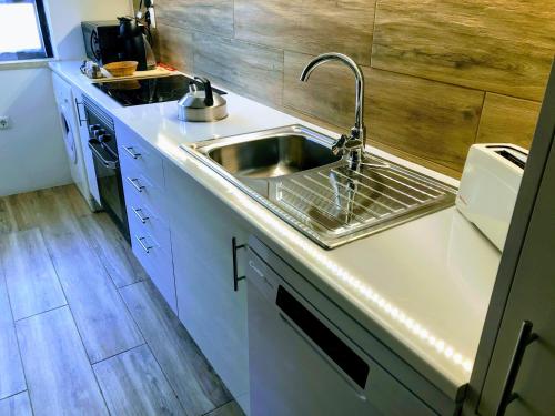a small kitchen with a sink and a stove at Cardoso Beirao in Carvoeiro